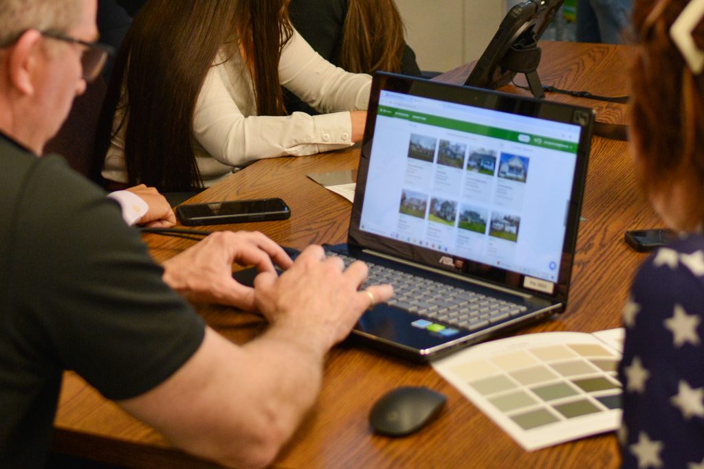 Patriot staff member working on computer during a planning session.