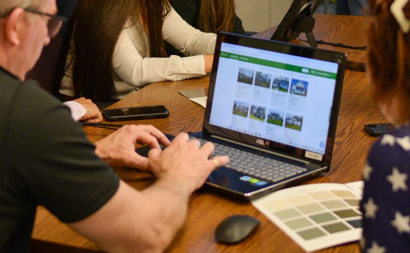 Patriot staff member working on computer during a planning session.