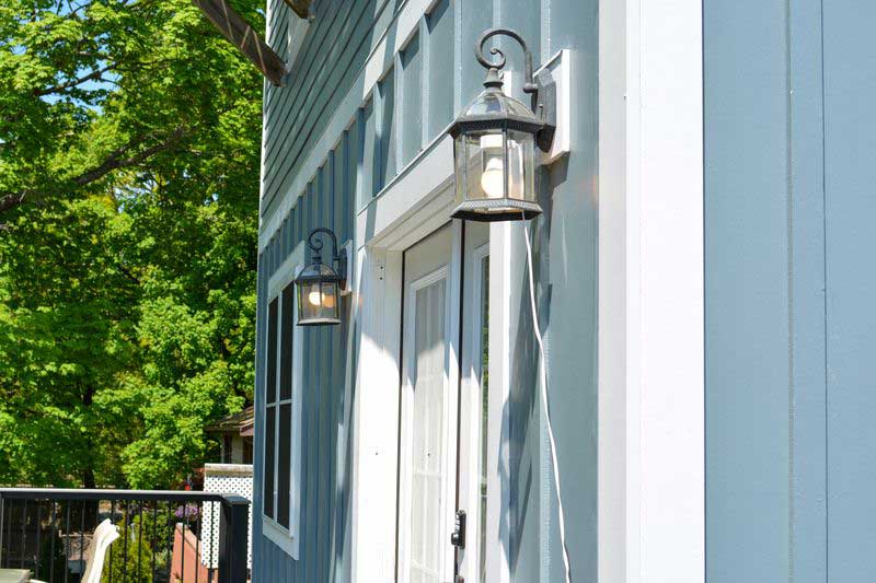 Closeup of newly installed siding and windows on the deck of a house.