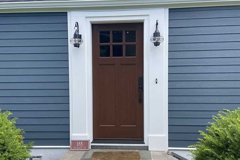 Closeup of a newly installed door and siding on a home.