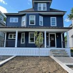 A newly constructed home with porch, siding, doors, and windows from Patriot Contracting.