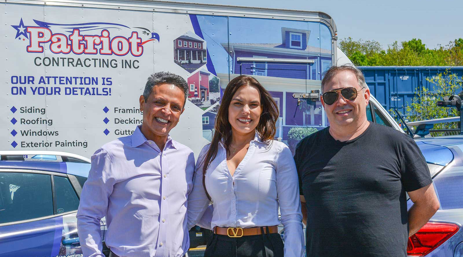 Patriot Contracting executive team standing in front of branded vehicles.