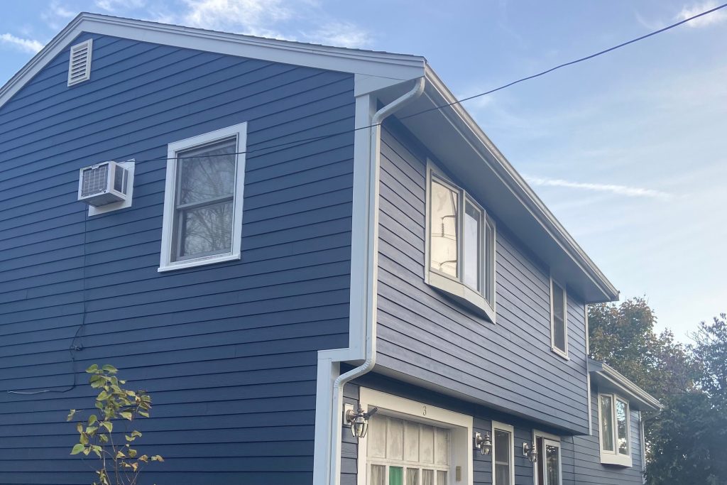 Closeup of a freshly installed siding, roof, and gutter systems by Patriot Contracting.