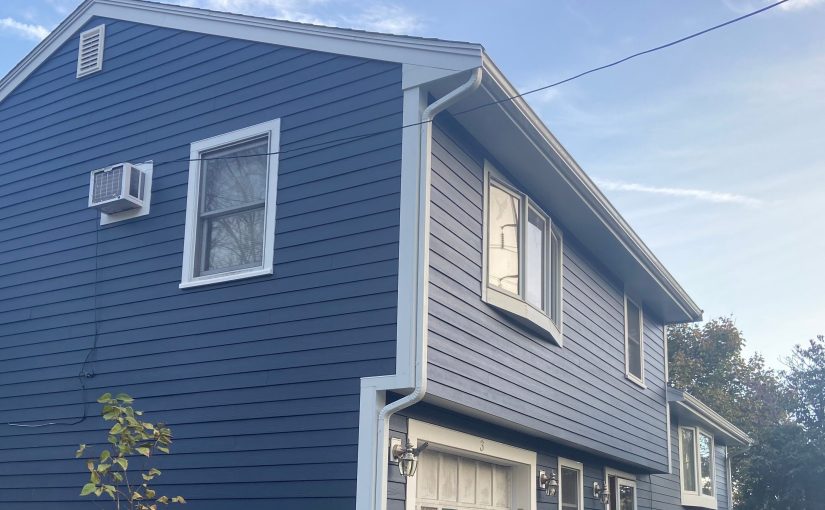 Closeup of a freshly installed siding, roof, and gutter systems by Patriot Contracting.