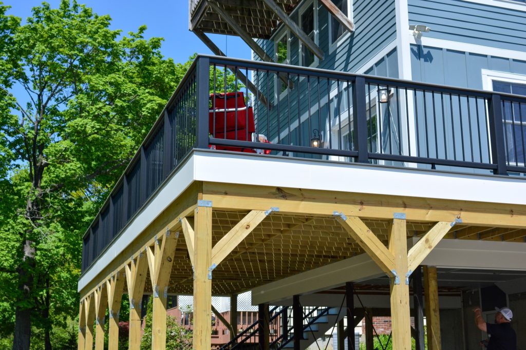 Newly installed wraparound deck and siding on home exterior.