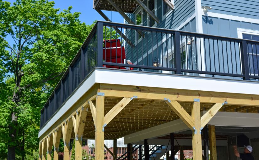 Newly installed wraparound deck and siding on home exterior.